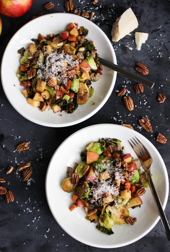 Two plates of Pan-Roasted Brussels Sprouts served on white dishes.