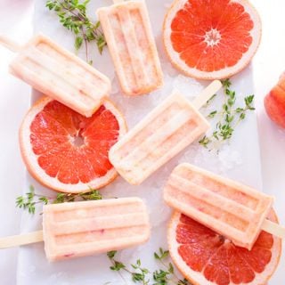 Grapefruit Peach Popsicles with Maple + Thyme - Keep cool and eat these grapefruit peach popsicles! This refreshing treat features pink grapefruit, sweet peaches, yogurt & thyme infused maple syrup. | passmesometasty.com