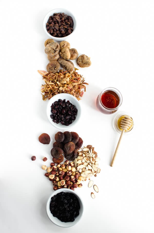 Dried fruit and nuts are laid out on a white background.