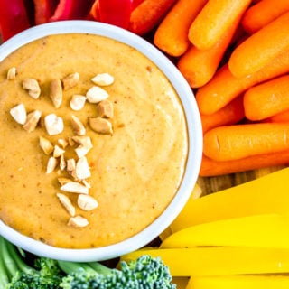 A dish of 5-Minute Peanut Sauce surrounded by a rainbow of veggies.