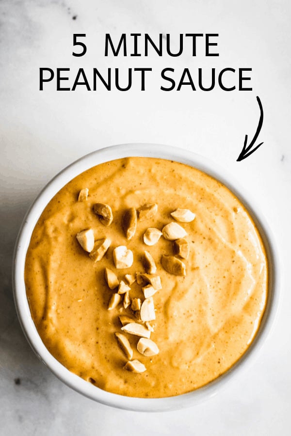 White dish with peanut sauce sprinkled with chopped peanuts.