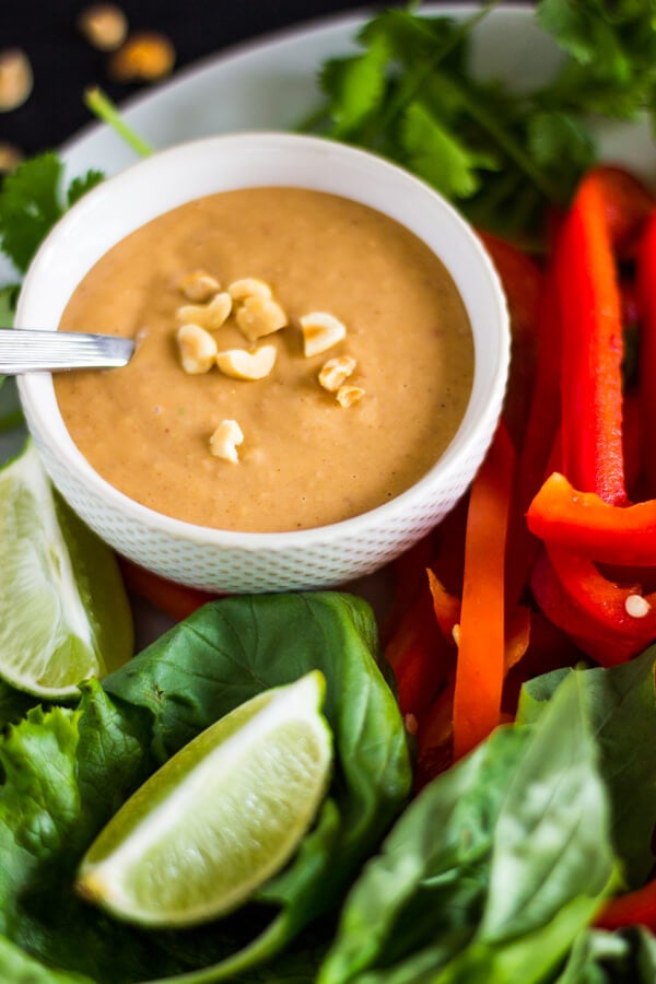 A plate of mixed veggies for to include in your spring rolls and a small dish of peanut sauce for dipping.