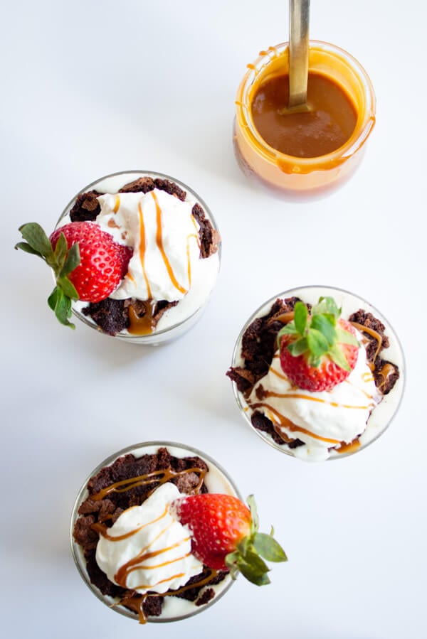 Salted Caramel Brownie Ice Cream Parfaits | Dessert | Gluten Free Recipe | Layers of warm brownie, ice cream, and salted caramel topped with homemade whipped cream and strawberries are what these dessert parfait dreams are made of. | passmesometasty.com