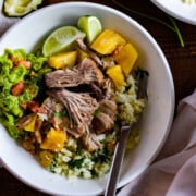 A plate of slow cooker pineapple pulled pork with cauliflower rice and guacamole.