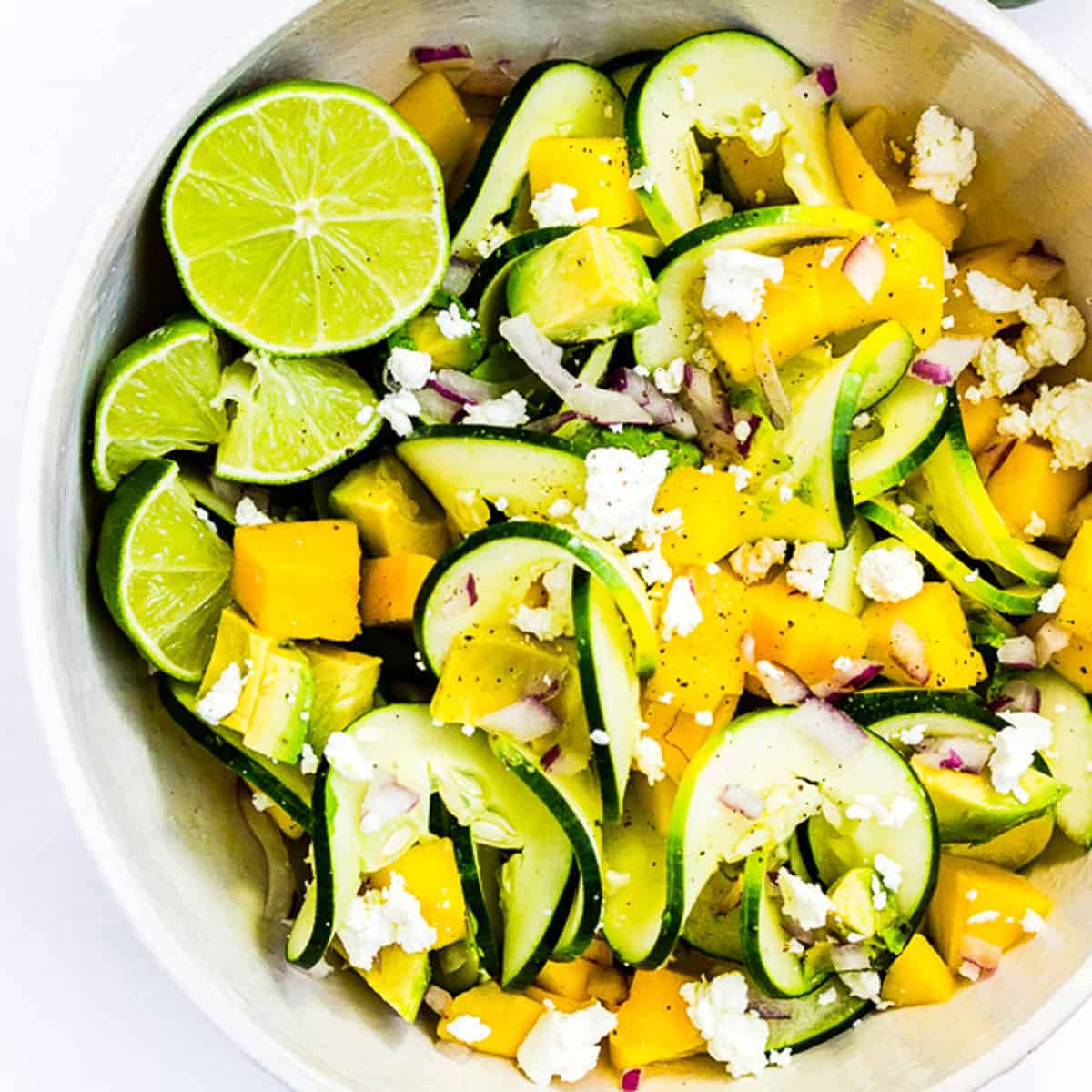 A beautiful salad of spiralized cucumbers, mango, avocado, and soft goat cheese with lime.