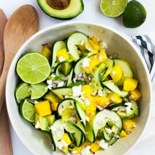 A beautiful salad of spiralized cucumbers, mango, avocado, and soft goat cheese with lime.