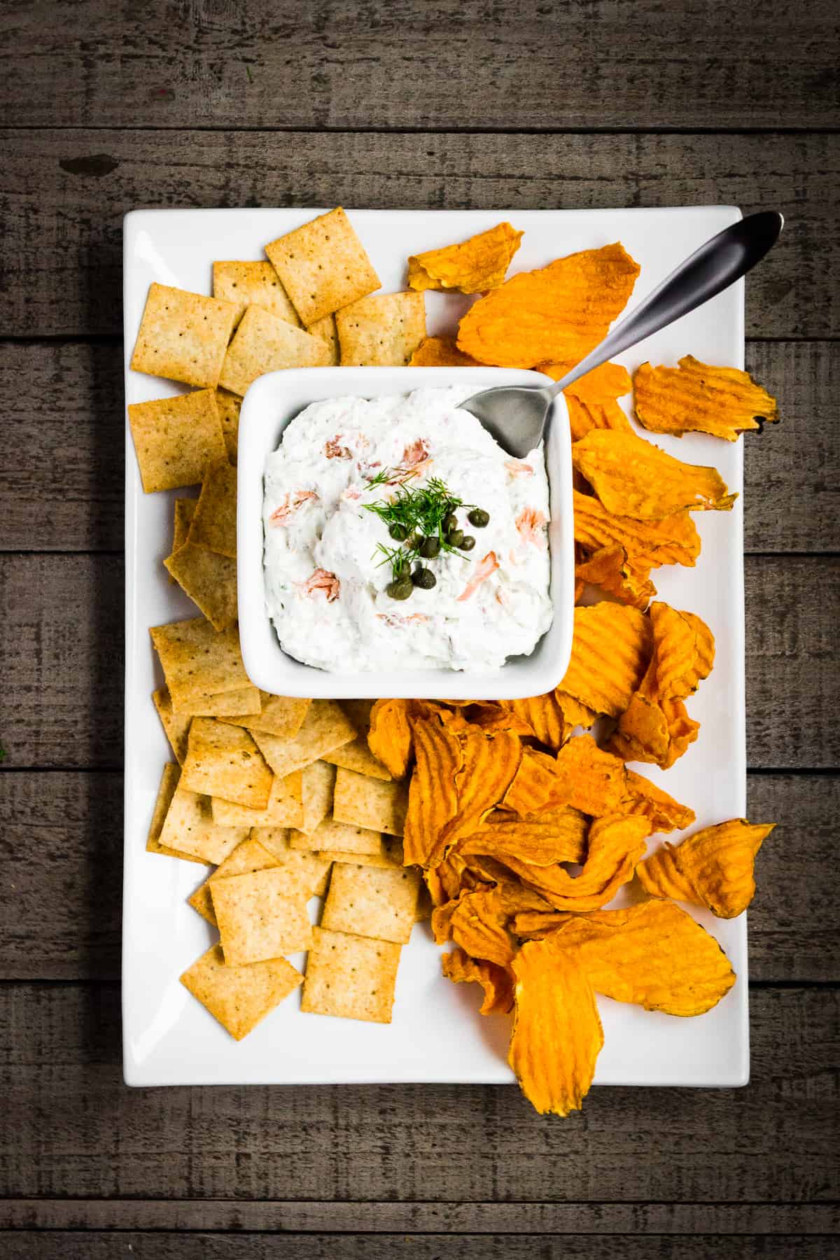 Smoked salmon dip with dill and capers served with almond crackers and sweet potato chips.