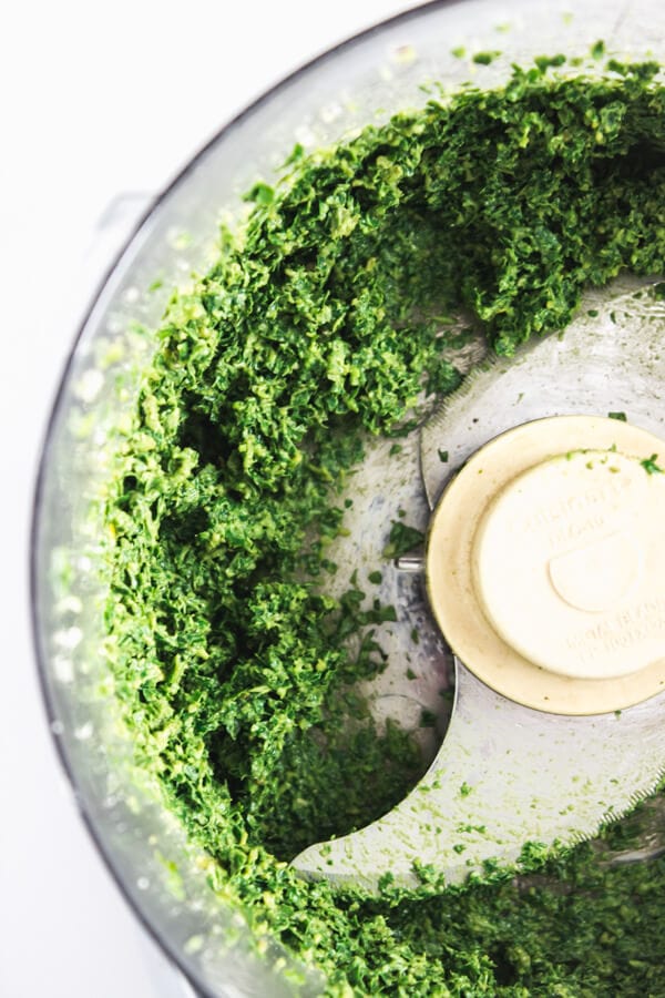 Fresh basil is processed with garlic and pine nuts.