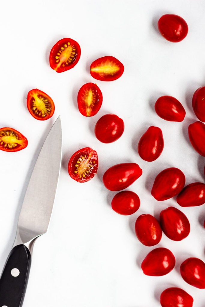 Sweet grape tomatoes and a paring knife.