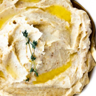A close-up view of creamy roasted mashed garlic cauliflower.