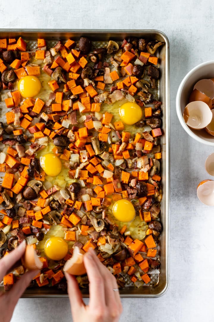 The vegetable are roasted and now eggs are cracked over top to be baked for an additional 5-10 minutes.