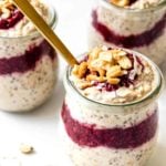 Three jars of overnight oats with berries, peanut butter, chia, and flax.