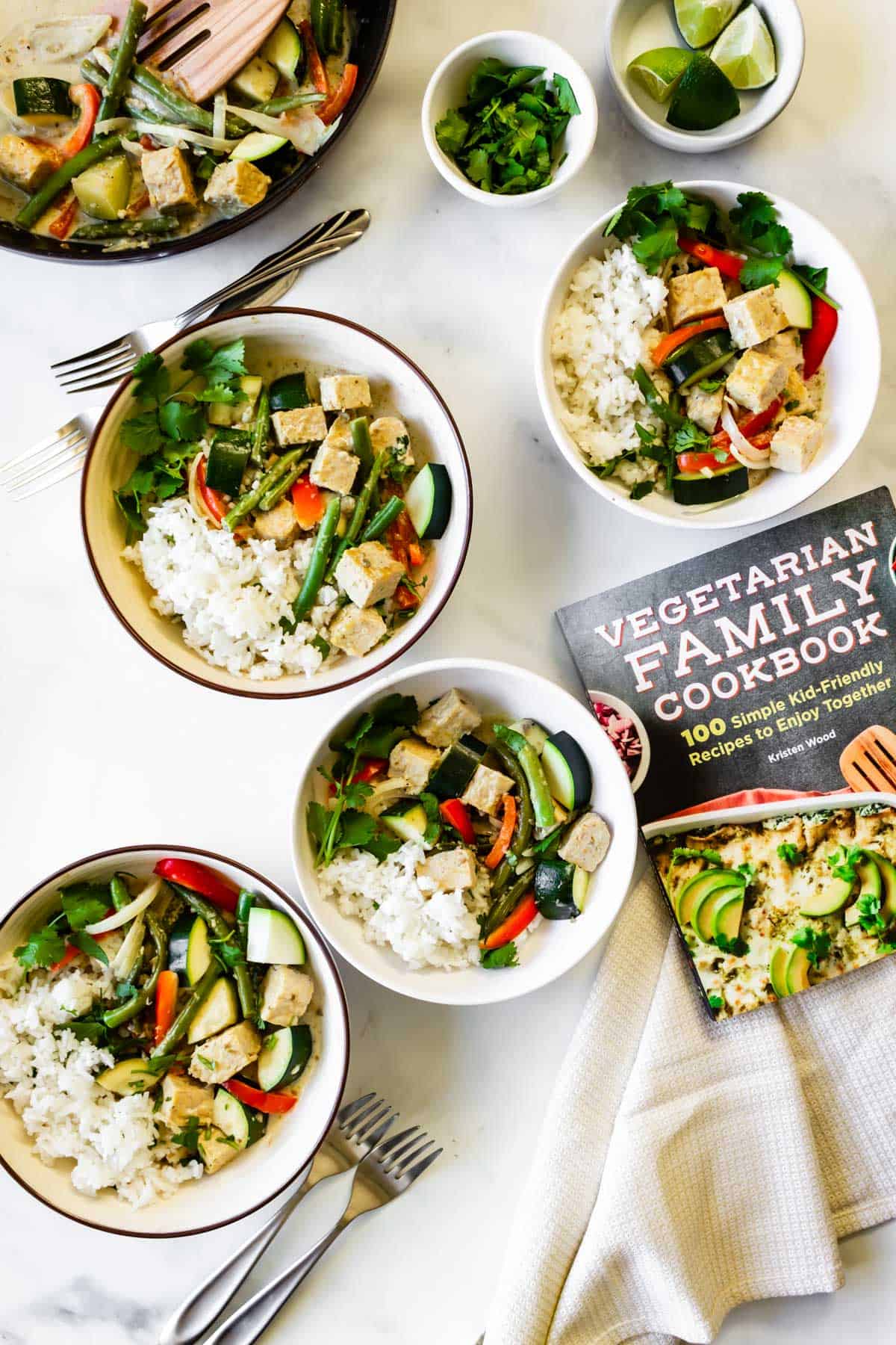 Tempeh green curry rice bowls and a cookbook.