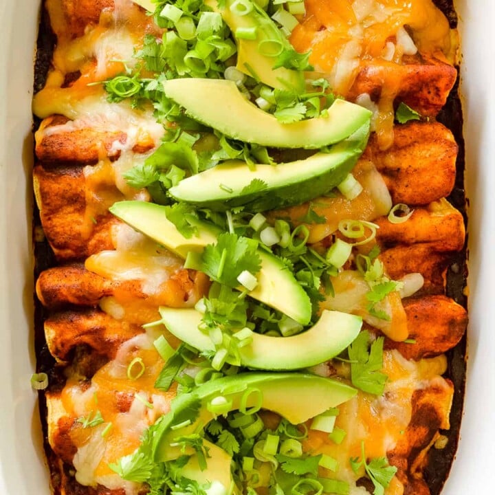 Cheesy chicken enchiladas with red sauce.