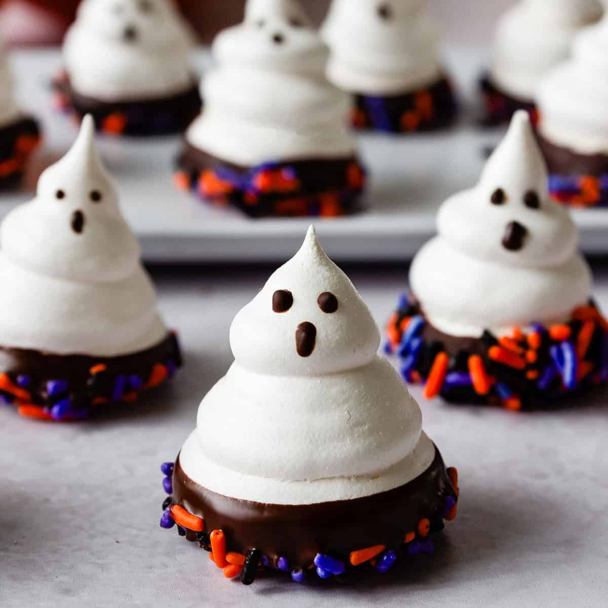 Meringue ghosts dipped in chocolate and sprinkles.