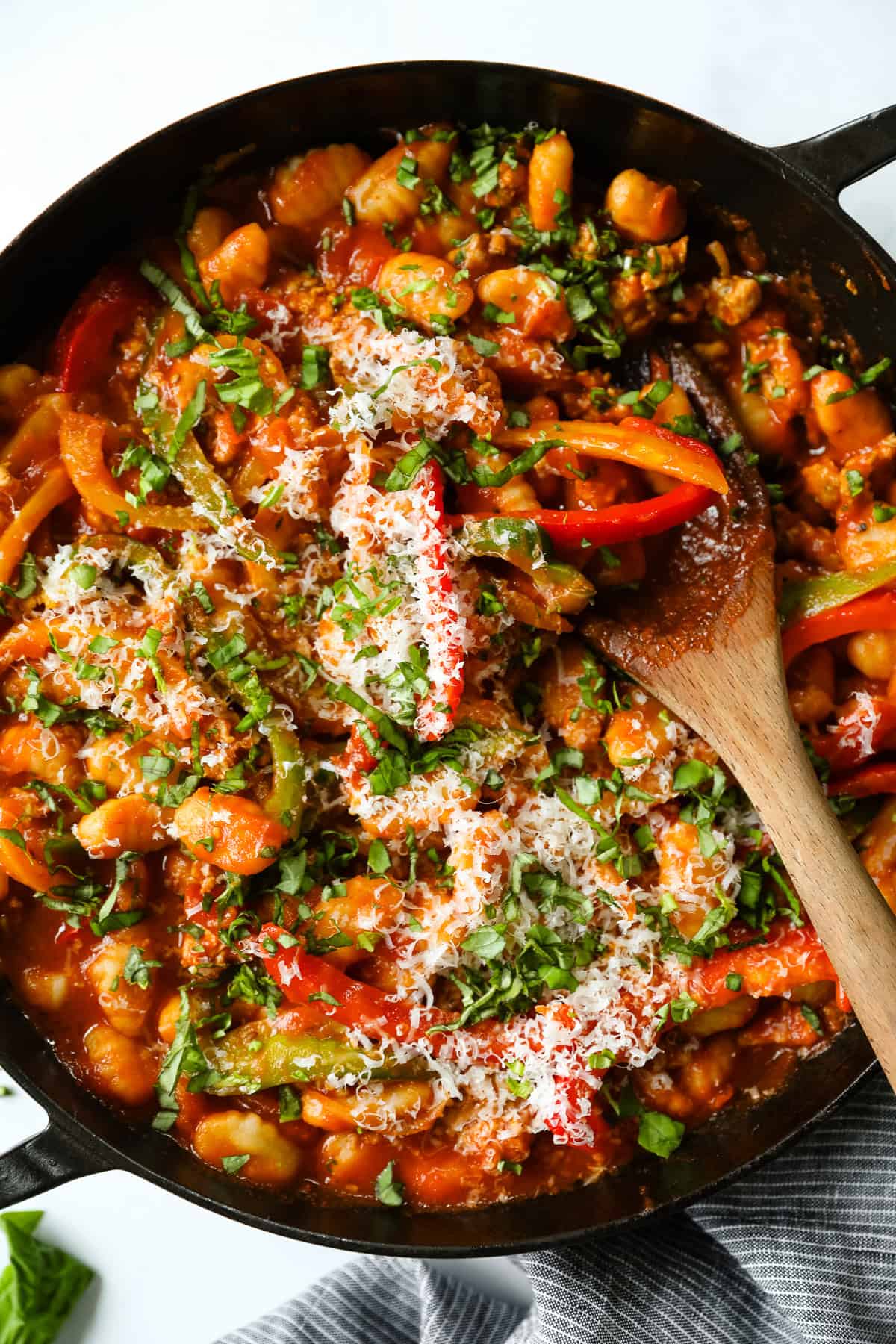 A skillet of gnocchi marinara with sausage and bell peppers.