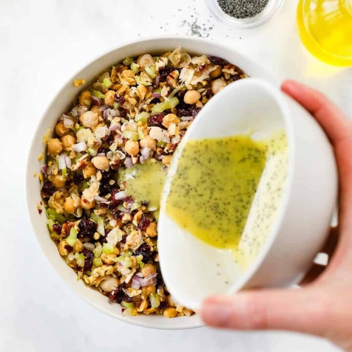 Dijon poppy seed dressing is poured onto chickpea mixture.